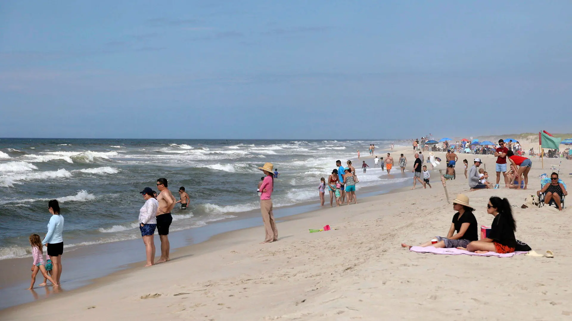 People are seen at Field 3 at Robert Moses State Park in West Islip, N.Y., Tuesday, July 4, 2023. Two swimmers were apparently attacked by sharks off the shores of Long Island on Tuesday, a day after two others reported being attacked while enjoying the water at popular New York beaches. (James Carbone/Newsday via AP)