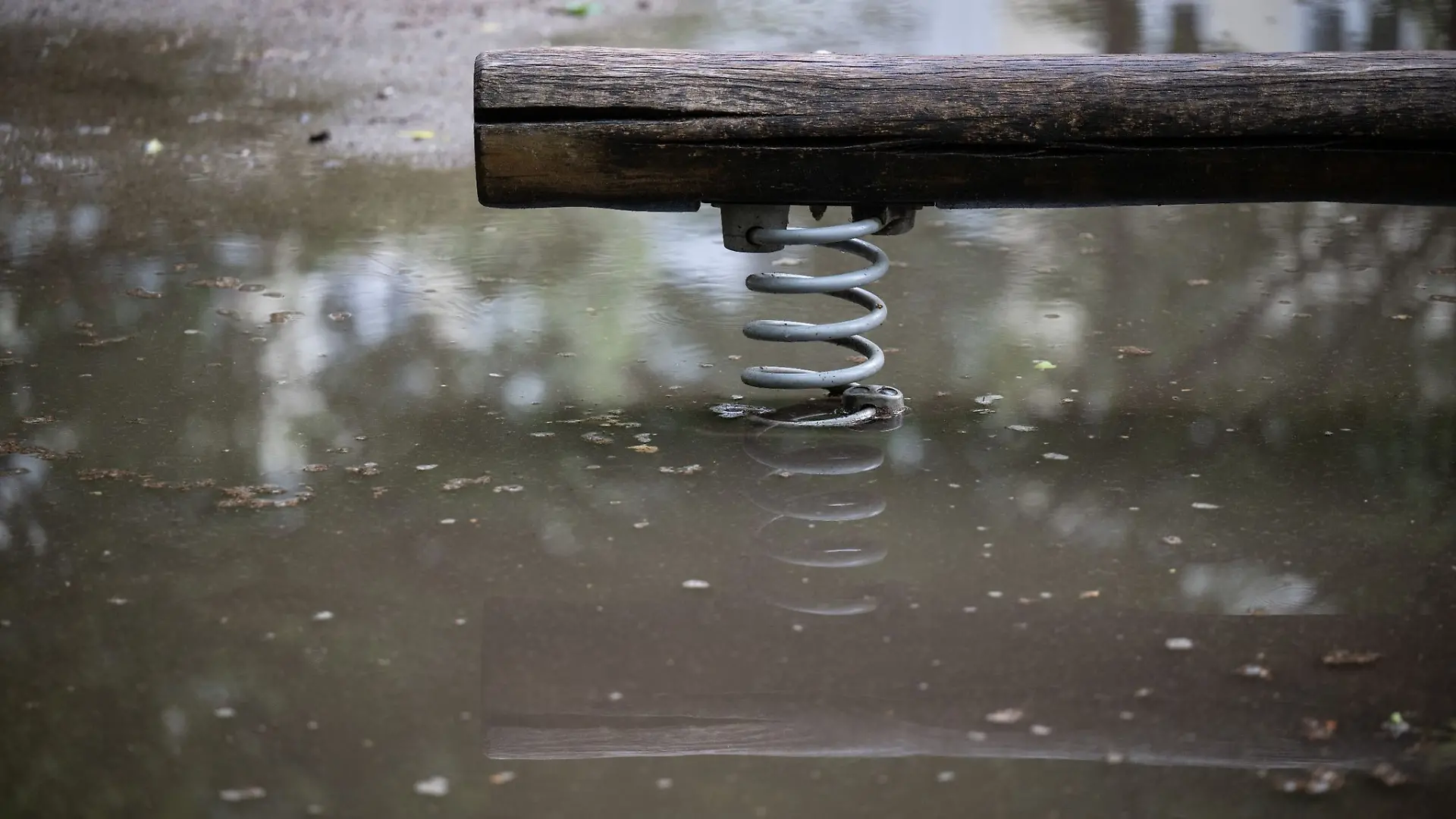 Eine Wippe auf einem Spielplatz steht im Wasser.