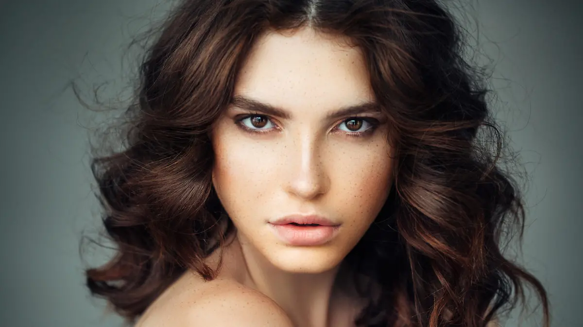 Studio shot of young beautiful woman. Professional make up and hair style.