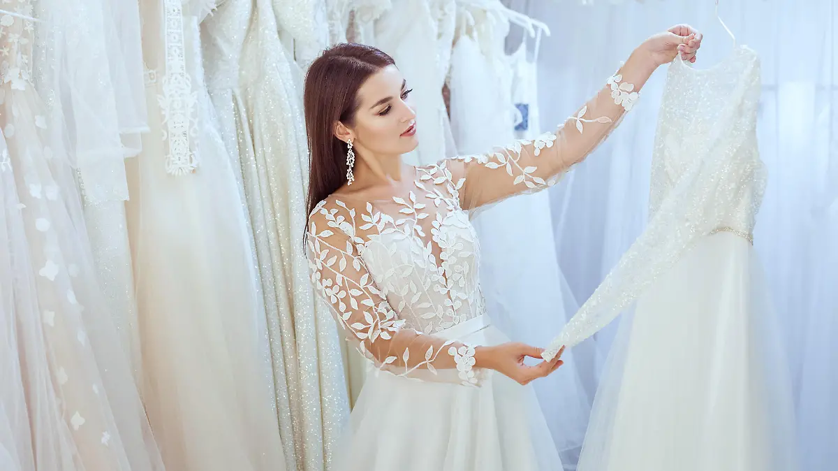 Frau probiert Hochzeitskleider