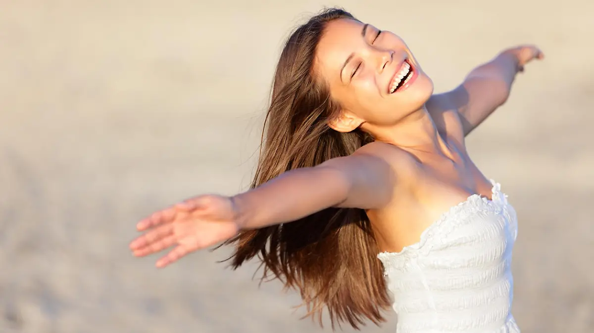 Happy vacation woman on beach summer holiday in cheerful bliss enjoying the sunshine. Beautiful ethnic girl in her 20s..Similars: