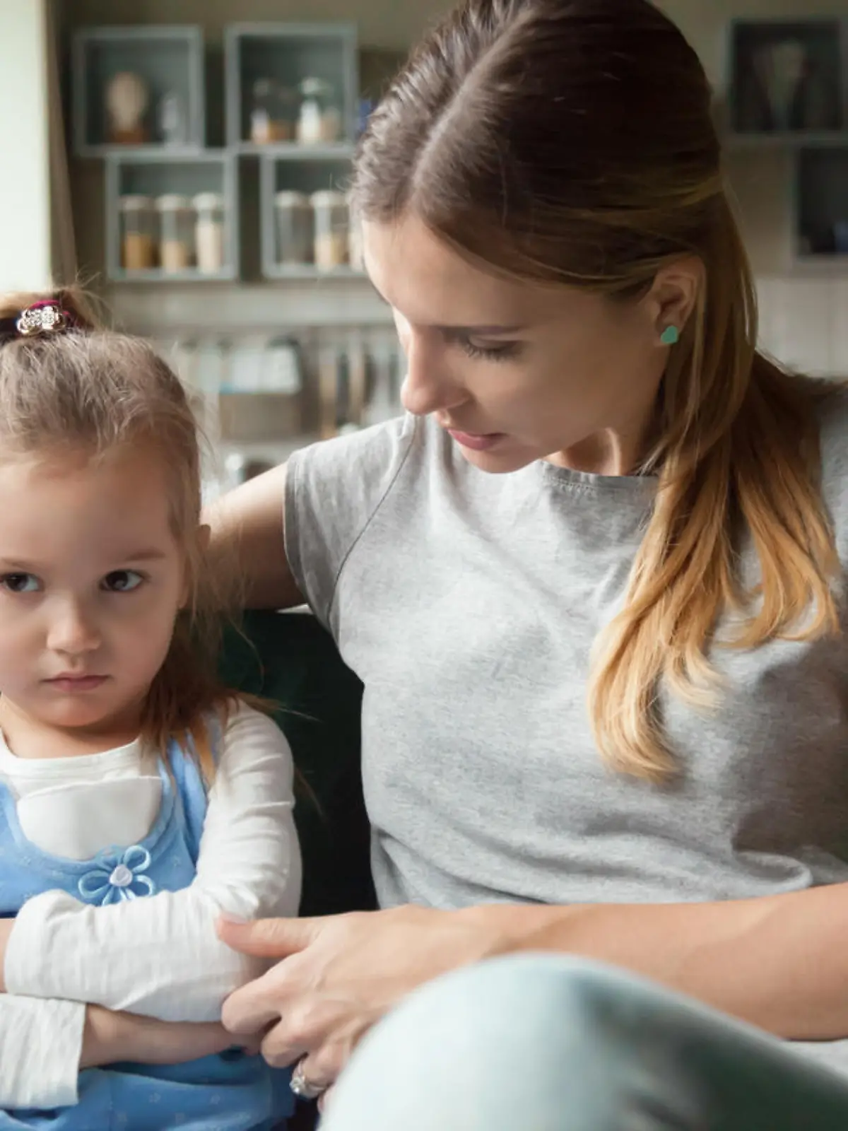 Loving mother consoling or trying make peace with insulted upset stubborn kid daughter avoiding talk, sad sulky resentful girl pouting ignoring caring mom embracing showing support to offended child