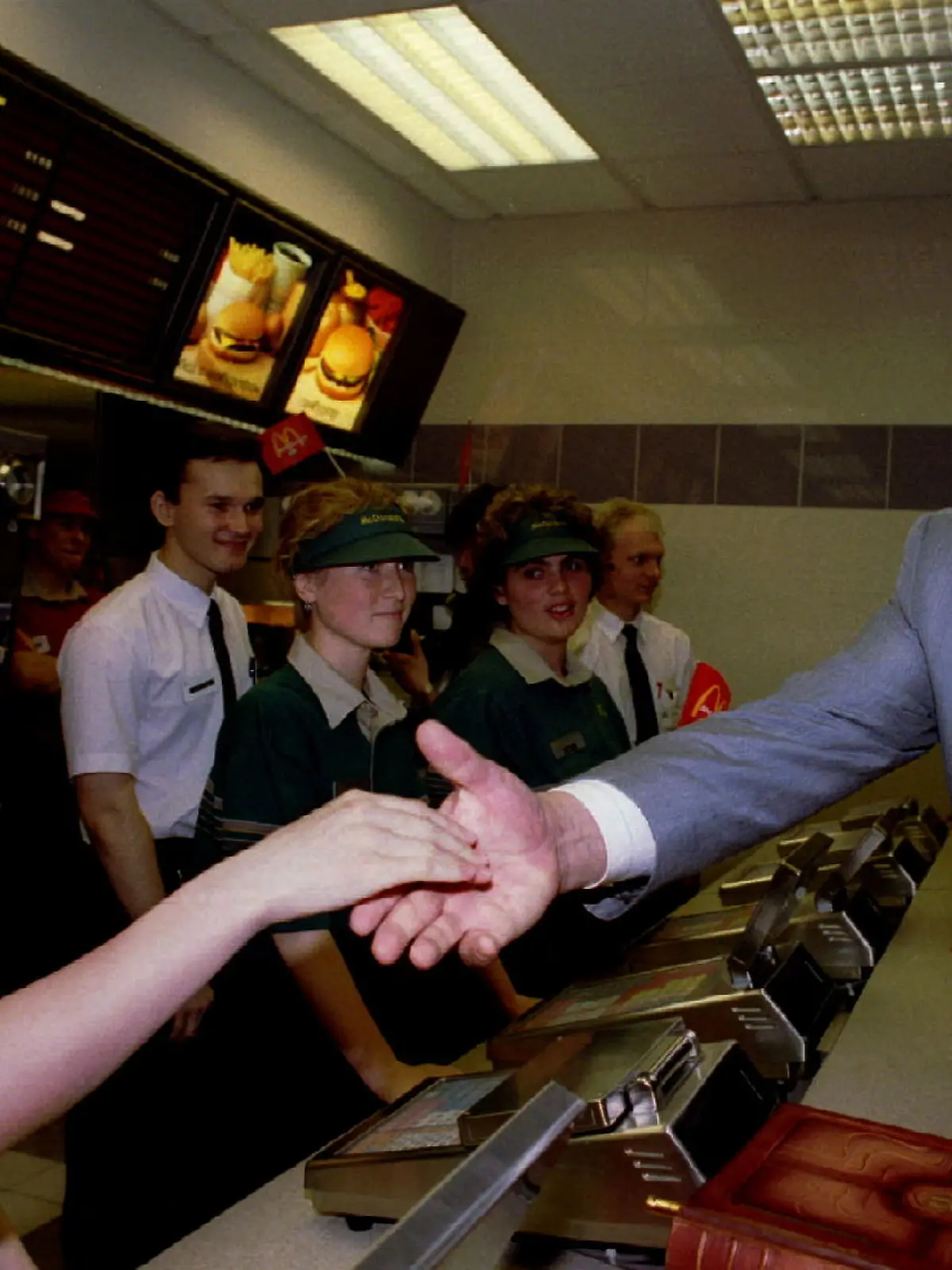 FILE PHOTO: Russian President Boris Yeltsin (R) shakes hands with a staff member at a McDonald's restaurant in Moscow, Russia, 1990. REUTERS/Gennady Galperin/File Photo