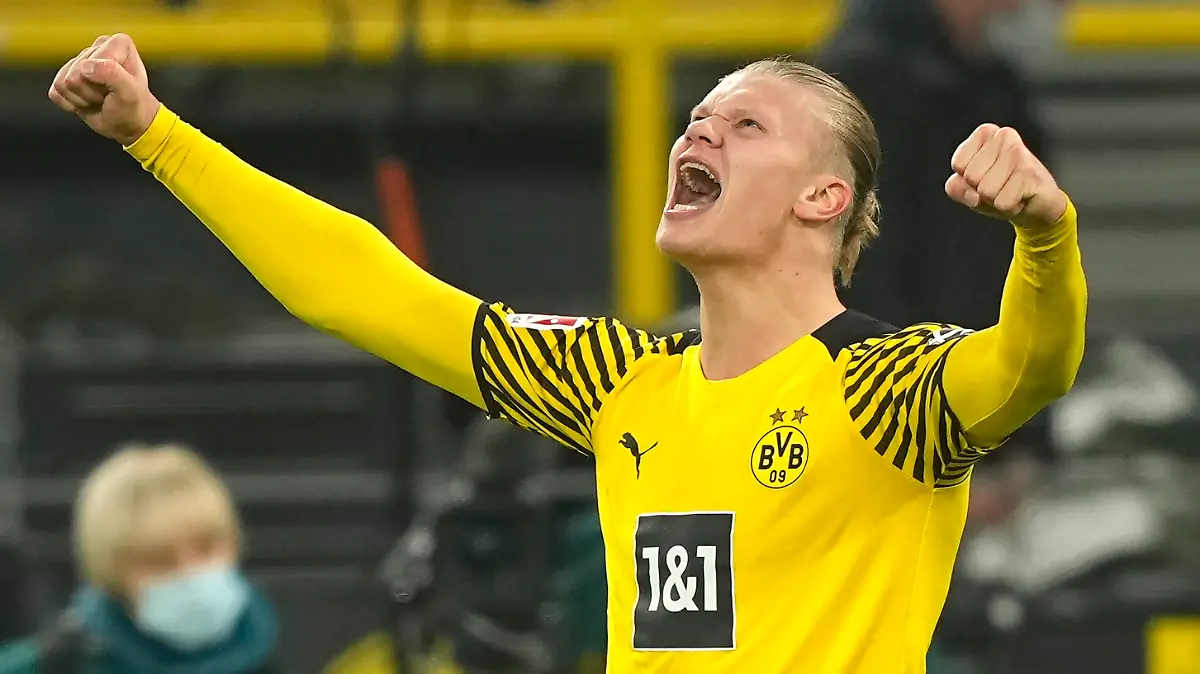 FILE - Dortmund's Erling Haaland celebrates the fourth goal of his team against Freiburg during the German Bundesliga soccer match between Borussia Dortmund and SC Freiburg in Dortmund, Germany, Friday, Jan. 14, 2022. Erling Haaland looks sure to be coming home. The future of the Norway striker is set to be finalized this week and the expectation is he will leave Borussia Dortmund to join Manchester City as the English club’s belated replacement for Sergio Aguero. The 21-year-old Haaland is one of the rising stars of world soccer. (AP Photo/Martin Meissner, File)