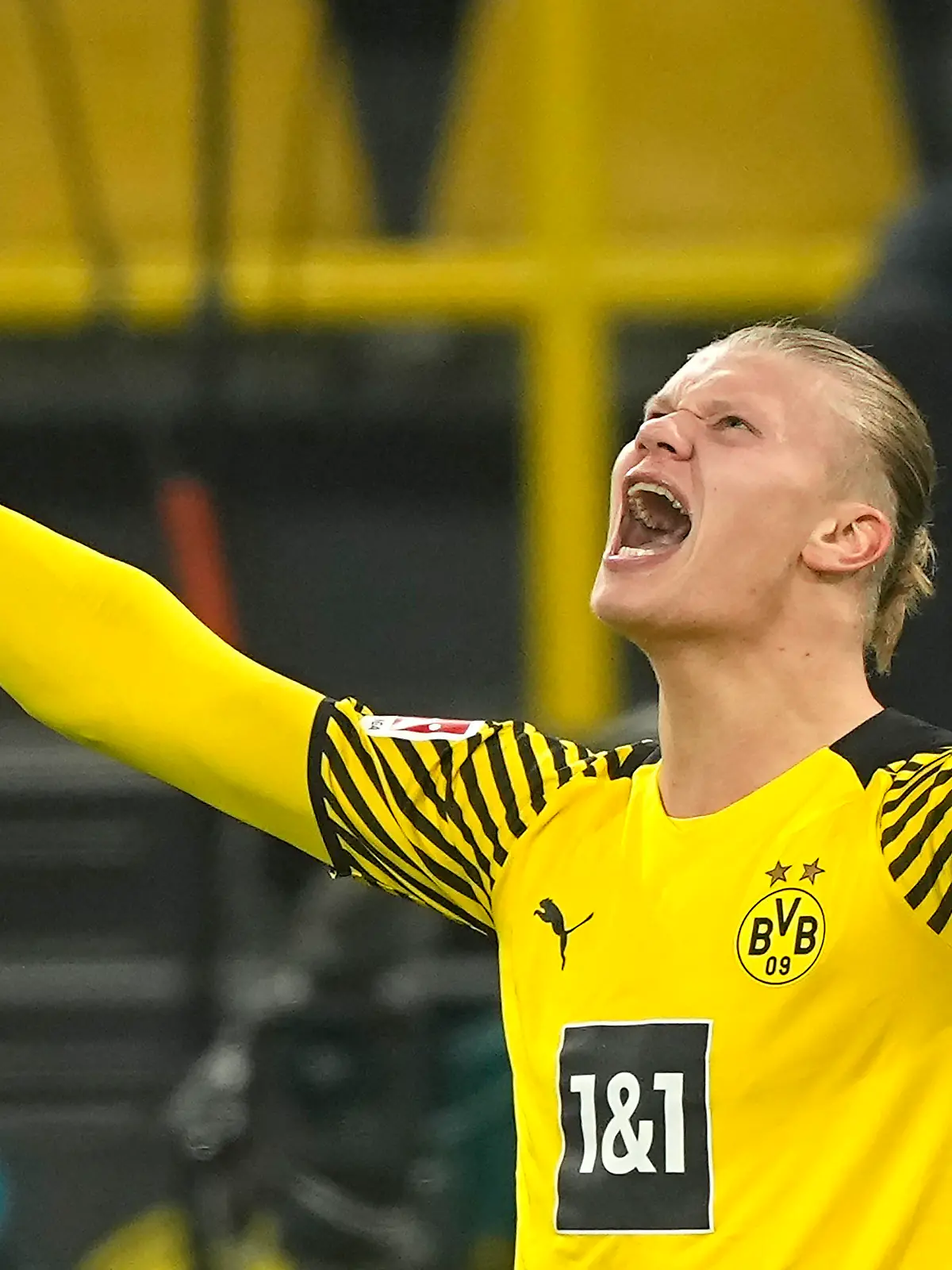 FILE - Dortmund's Erling Haaland celebrates the fourth goal of his team against Freiburg during the German Bundesliga soccer match between Borussia Dortmund and SC Freiburg in Dortmund, Germany, Friday, Jan. 14, 2022. Erling Haaland looks sure to be coming home. The future of the Norway striker is set to be finalized this week and the expectation is he will leave Borussia Dortmund to join Manchester City as the English club’s belated replacement for Sergio Aguero. The 21-year-old Haaland is one of the rising stars of world soccer. (AP Photo/Martin Meissner, File)
