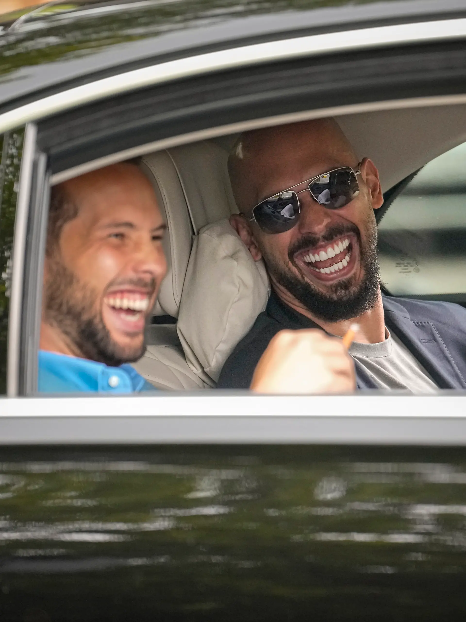 FILE - Andrew Tate, right, and his brother Tristan laugh as they leave the Bucharest Tribunal in Bucharest, Romania, Wednesday, May 8, 2024. A court in Romania’s capital on Friday, July 5, 2024 ruled that the online influencer Andrew Tate can leave Romanian territory providing he remains within the European Union, as he awaits trial on charges of human trafficking, rape and forming a criminal gang to sexually exploit women. (AP Photo/Vadim Ghirda, File)