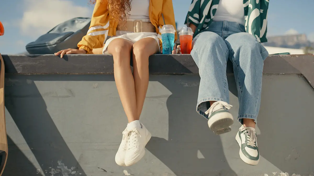Relax, shoes and summer with friends at skate park for bonding, calm and hipster. Cheers, mockup and teenager with closeup of people in outdoors for skating, fitness and sports training together