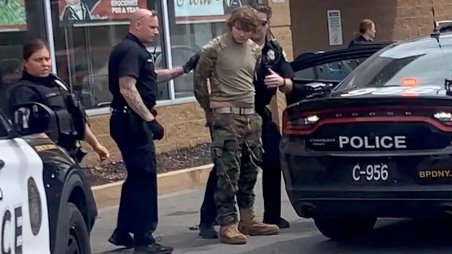 A man is detained following a mass shooting in the parking lot of TOPS supermarket, in a still image from a social media video in Buffalo, New York, U.S. May 14, 2022. Courtesy of BigDawg/ via REUTERS THIS IMAGE HAS BEEN SUPPLIED BY A THIRD PARTY. MANDATORY CREDIT