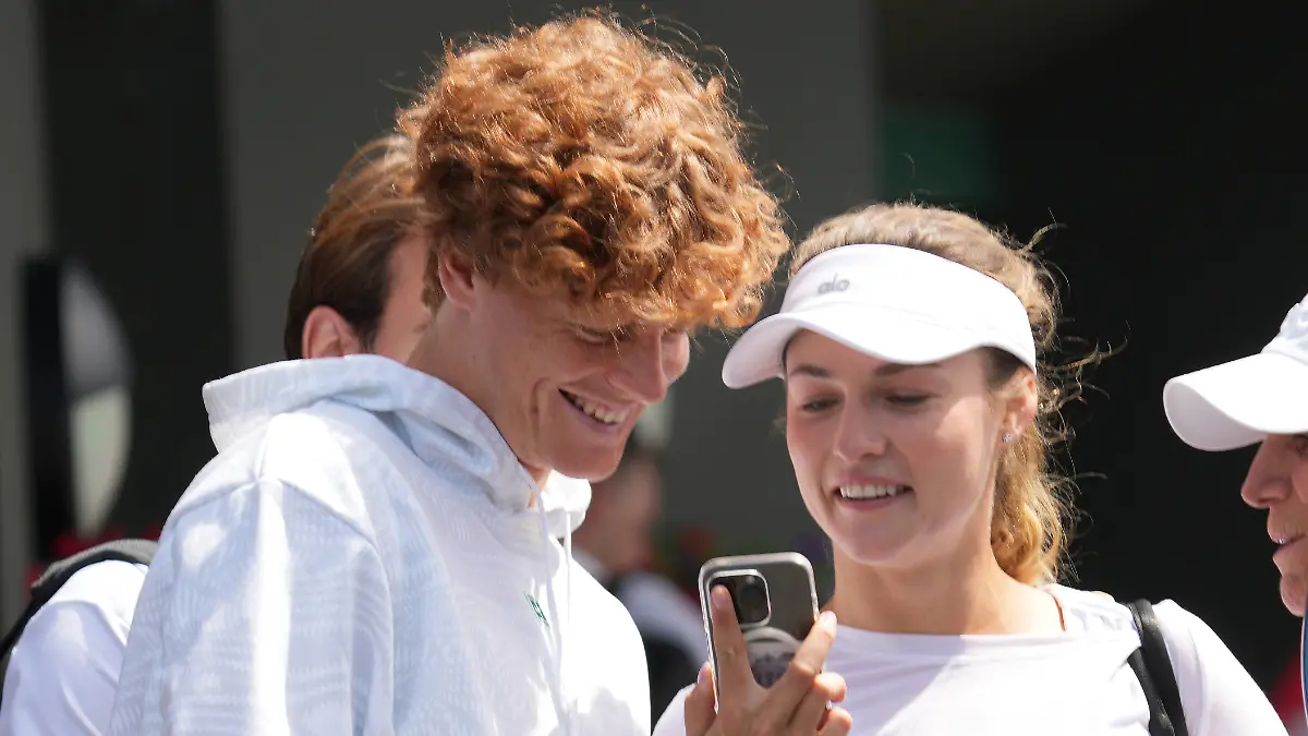 Tennis - 2024 Wimbledon Championships Training practice Yannick Sinner Italy with girlfriend, Anna Kalinskaya share a joke on her mobile after training