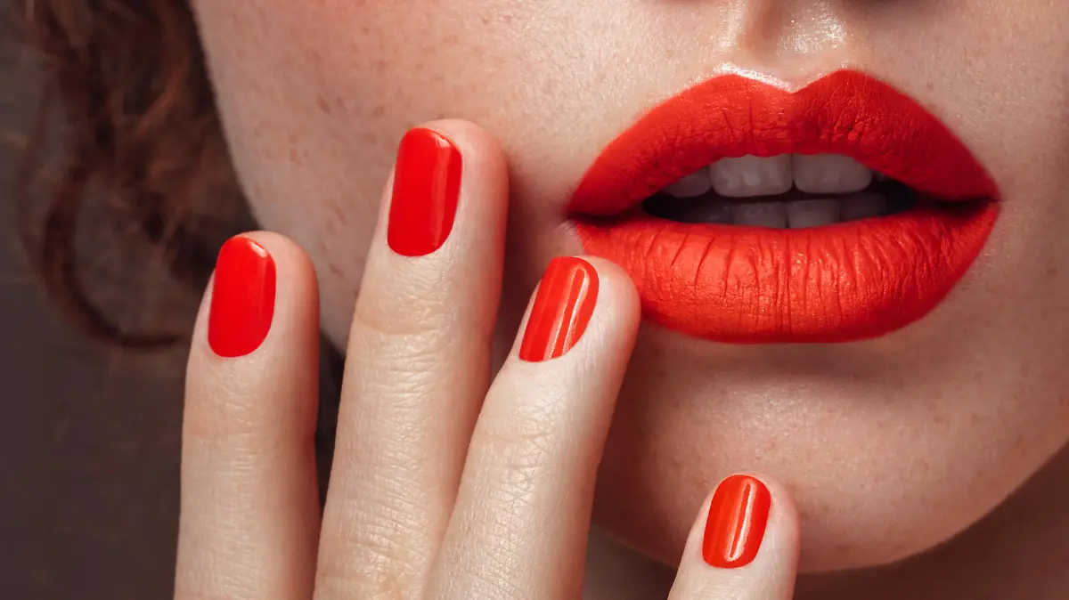 Woman's red lips and manicure close-up