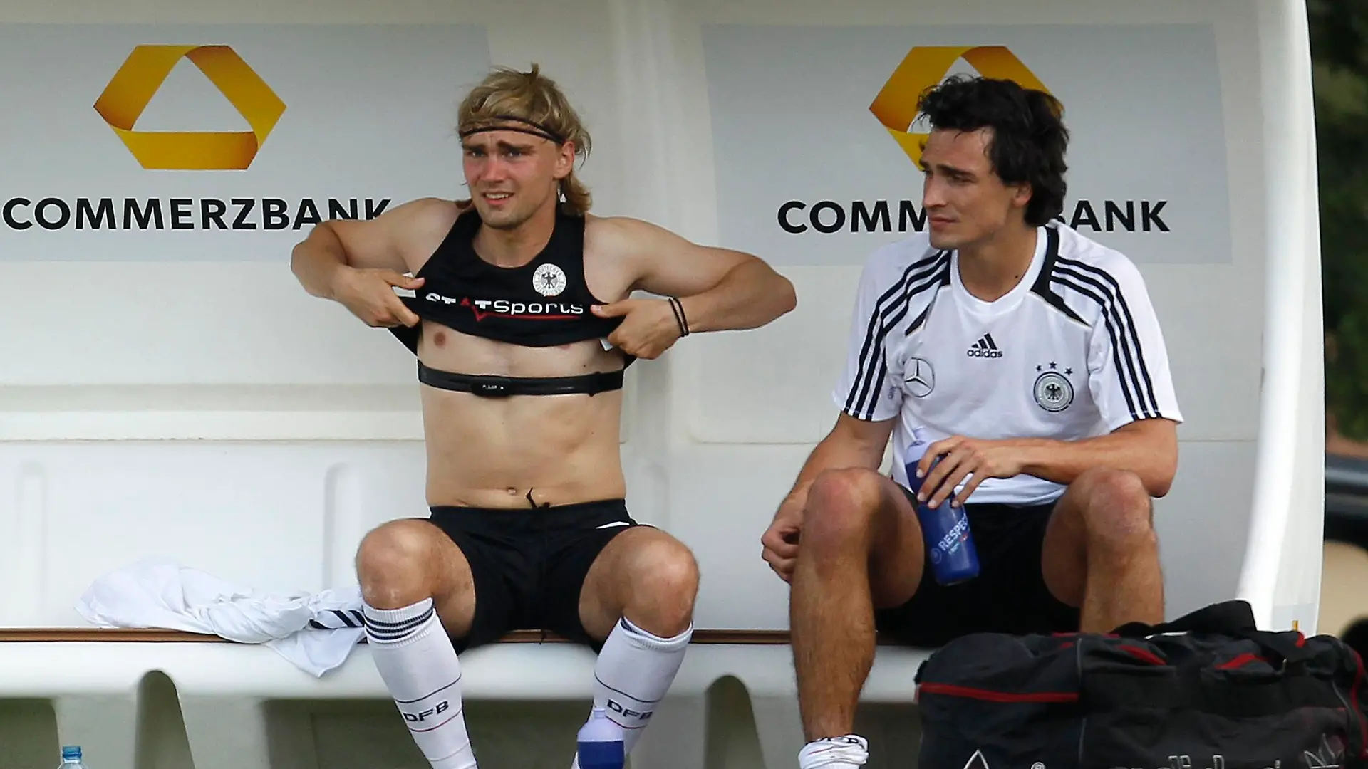 German national soccer player Marcel Schmelzer (L) takes off a jersey, while Mats Hummels looks on after a training session in Tourrettes, southern France, May 28, 2012. The German national soccer team started a training camp in Tourrettes near Cannes on May 18. REUTERS/Ina Fassbender (FRANCE - Tags: SPORT SOCCER)