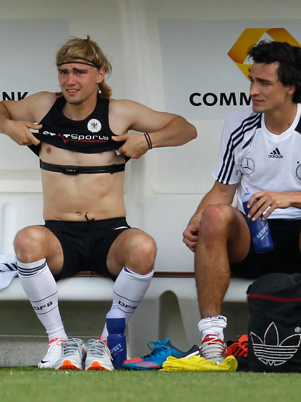 German national soccer player Marcel Schmelzer (L) takes off a jersey, while Mats Hummels looks on after a training session in Tourrettes, southern France, May 28, 2012. The German national soccer team started a training camp in Tourrettes near Cannes on May 18.   REUTERS/Ina Fassbender (FRANCE - Tags: SPORT SOCCER)
