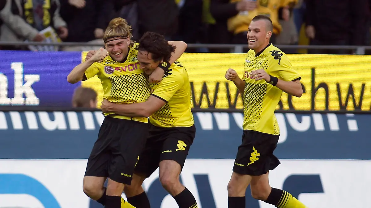 Borussia Dortmund's Marcel Schmelzer, Mats Hummels and Kevin Grosskreutz (L-R) celebrate a goal against Cologne during the German first division Bundesliga soccer match in Dortmund October 22, 2011. REUTERS/Ina Fassbender (GERMANY - Tags: SPORT SOCCER) DFL LIMITS USE OF IMAGES ON THE INTERNET TO 15 PICTURES DURING THE MATCH AND, PROHIBITS MOBILE (MMS) USE DURING AND UP TO 2 HOURS POST MATCH. FOR MORE INFORMATION CONTACT DFL