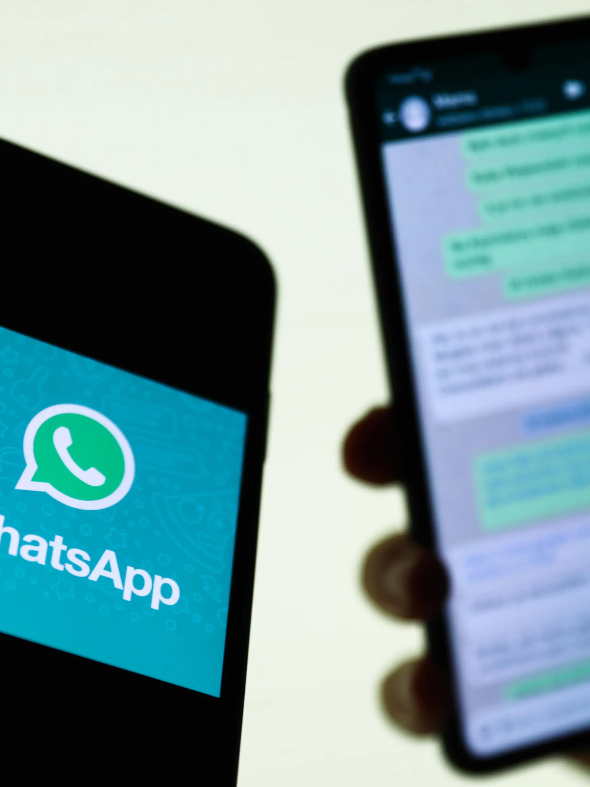 WhatsApp logo displayed on a phone screen and conversation on the WhatsApp displayed on a phone screen in the background are seen in this illustration photo taken in Krakow, Poland on August 27, 2021. (Photo Illustration by Jakub Porzycki/NurPhoto)