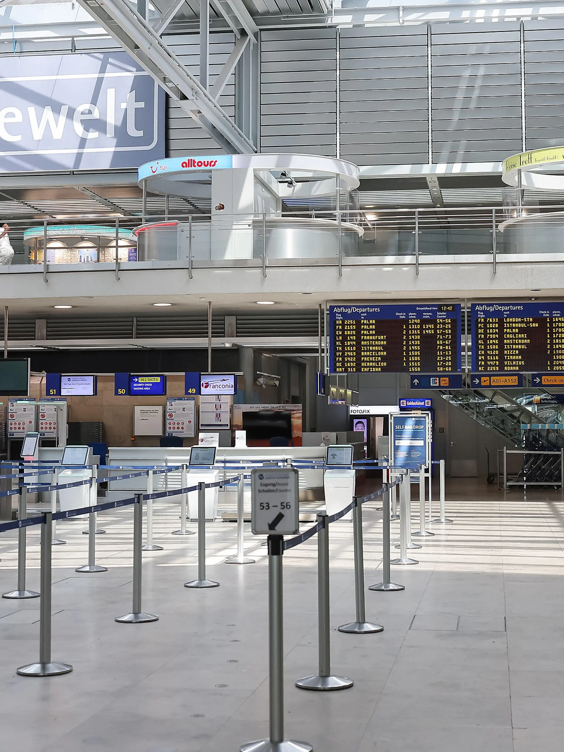 19.07.2024, Bayern, Nürnberg: Leere herrscht vor der automatisierten Gepäckaufnahme am Nürnberger Flughafen in der Abflughalle, das Anzeigendisplay am Nürnberger Flughafen zeigt zudem verspätete oder gestrichene Flüge an. Weltweite Probleme in den Computersystemen stören die An - und Abflüge bei Airlines am Nürnberger Flughafen. Foto: Daniel Löb/dpa +++ dpa-Bildfunk +++