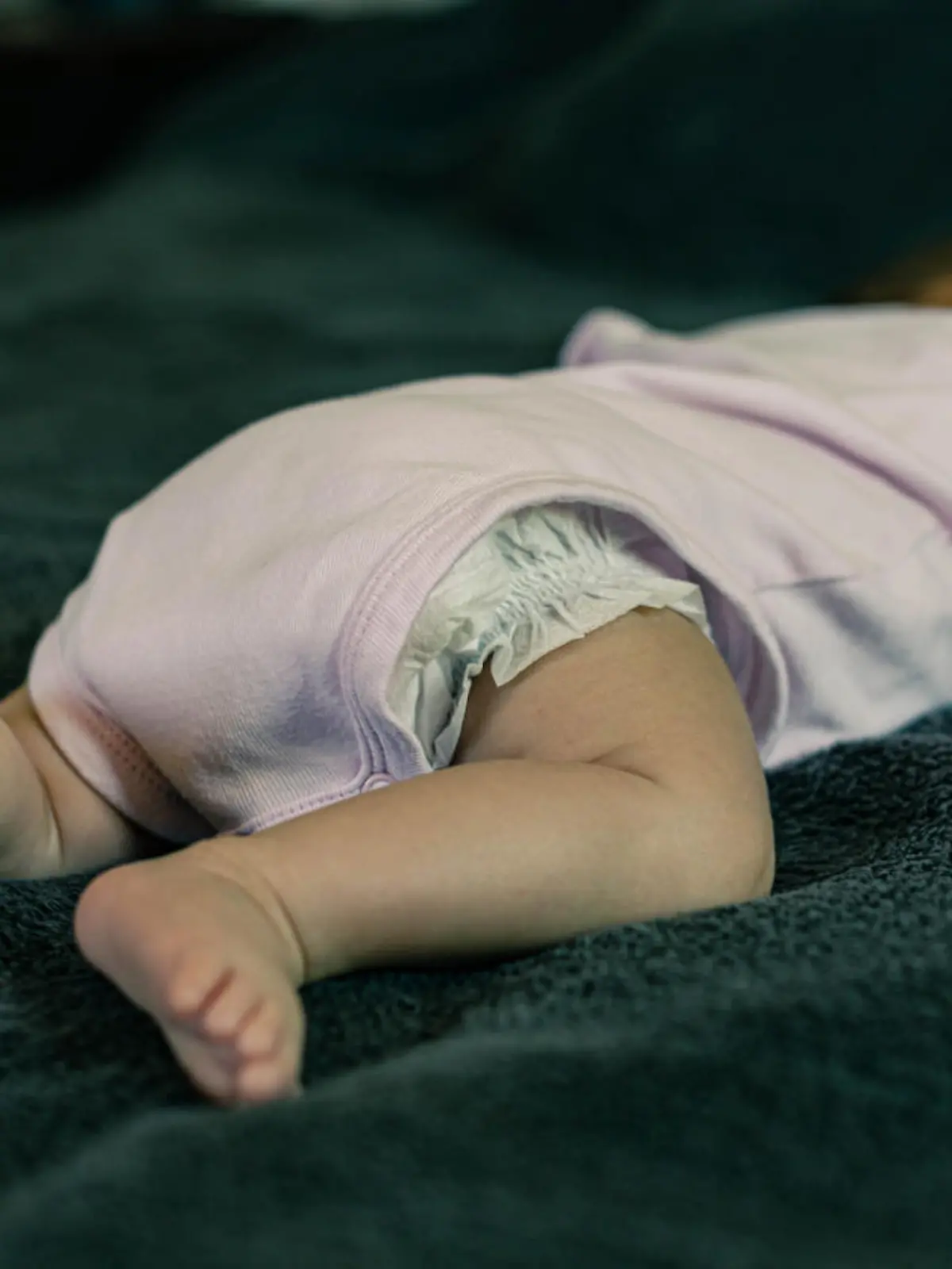 A baby infant sleeping on the stomach. Bad sleep position.