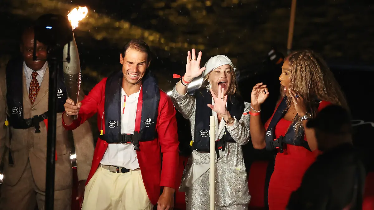 PARIS, FRANCE - JULY 26: 14 Time French Open Winner Rafael Nadal of Team Spain, American Former Tennis Player Serena Williams, American Track Athlete Carl Lewis and Romanian Gymnast Nadia Comaneci are seen on a boat with the Olympic Torch on the Seine during the opening ceremony of the Olympic Games Paris 2024 on July 26, 2024 in Paris, France. (Photo by Alex Davidson/Getty Images)