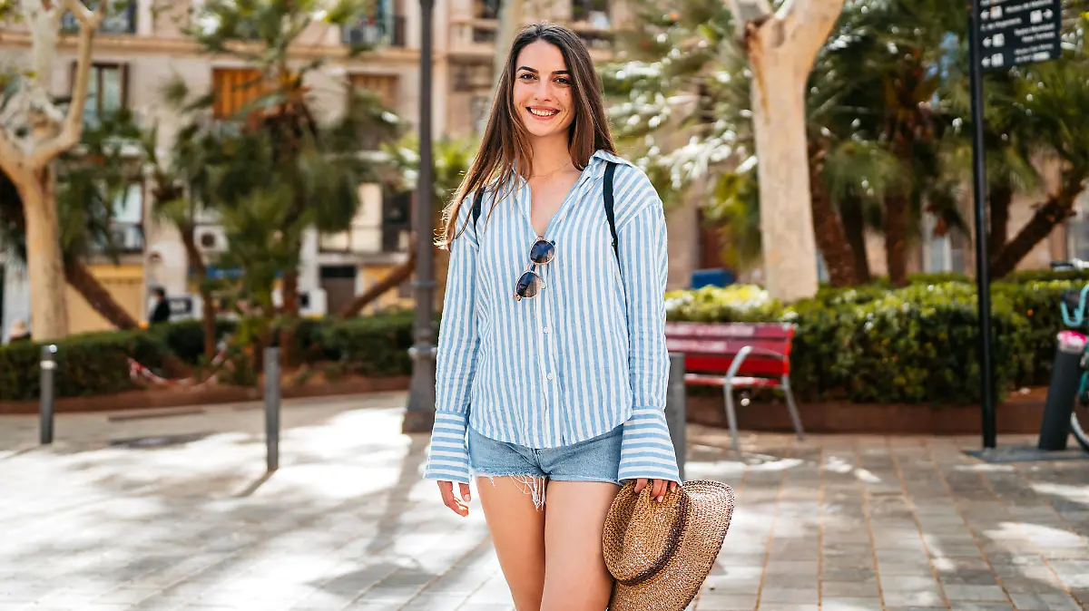 Portrait of a young female tourist on the street in Palma de Mallorca in Spain.