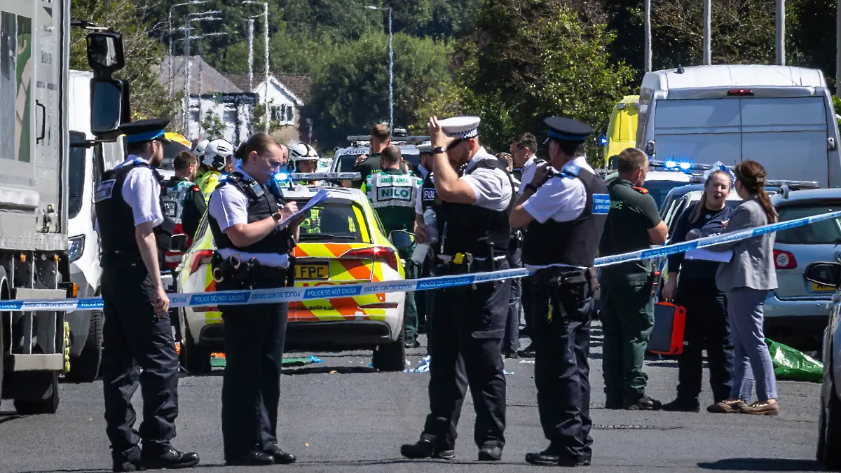 Police secure the area, where a man has been detained and a knife has been seized after a number of people were injured in a reported stabbing, in Southport, Merseyside, England, Monday July 29, 2024. (James Speakman/PA via AP)