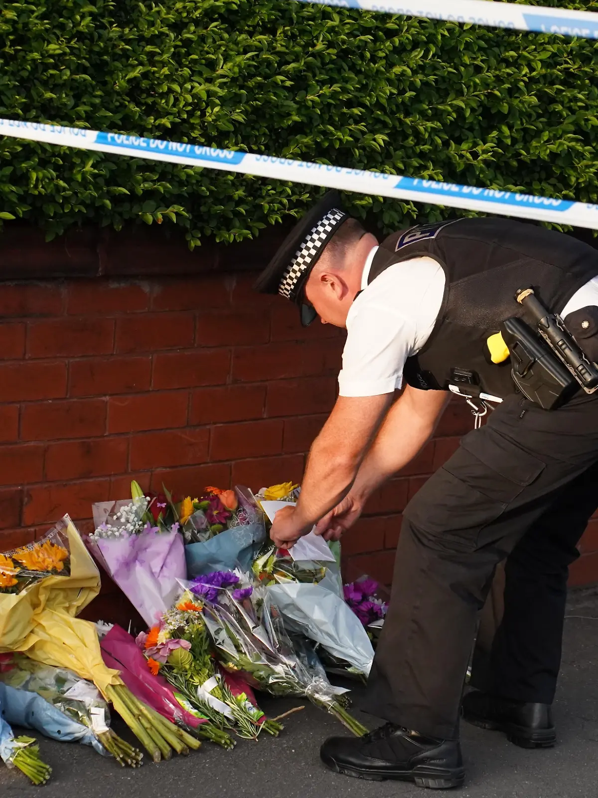 SOUTHPORT, UNITED KINGDOM - JULY 29: People lay flowers and pay their respects near the scene where an attack at a Taylor Swift themed yoga and dance workshop took place in Southport near Liverpool, United Kingdom on July 29, 2024. The North West Ambulance Service says 2 children died and 6 people are in critical condition. Ioannis Alexopoulos / Anadolu