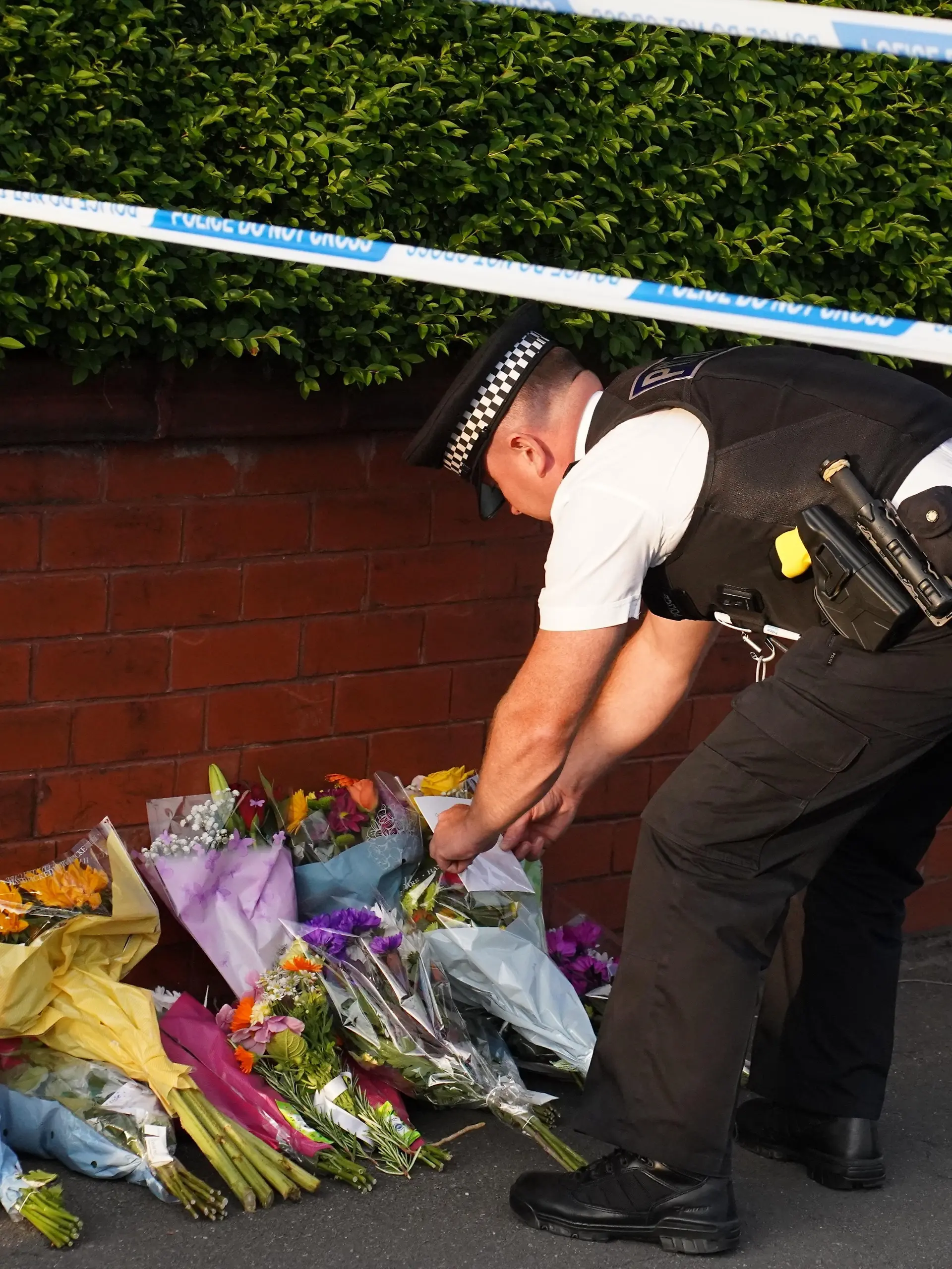 SOUTHPORT, UNITED KINGDOM - JULY 29: People lay flowers and pay their respects near the scene where an attack at a Taylor Swift themed yoga and dance workshop took place in Southport near Liverpool, United Kingdom on July 29, 2024. The North West Ambulance Service says 2 children died and 6 people are in critical condition. Ioannis Alexopoulos / Anadolu