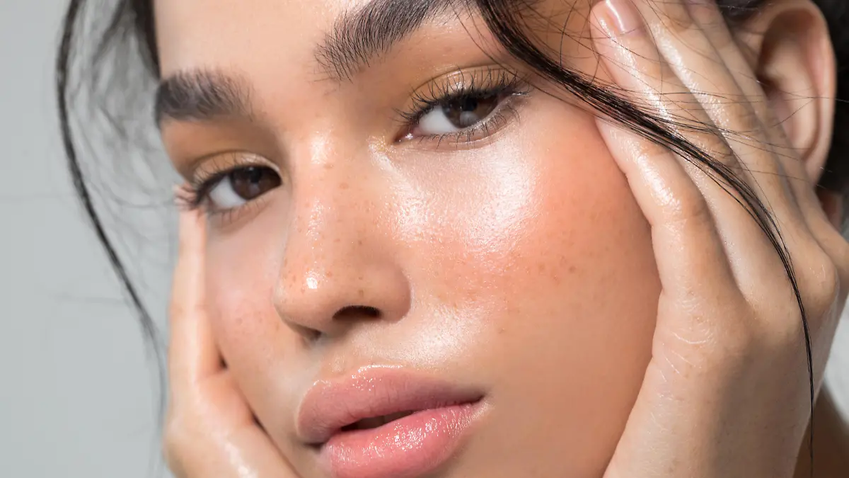 Close up studio shot of a beautiful young woman with perfect glow skin.