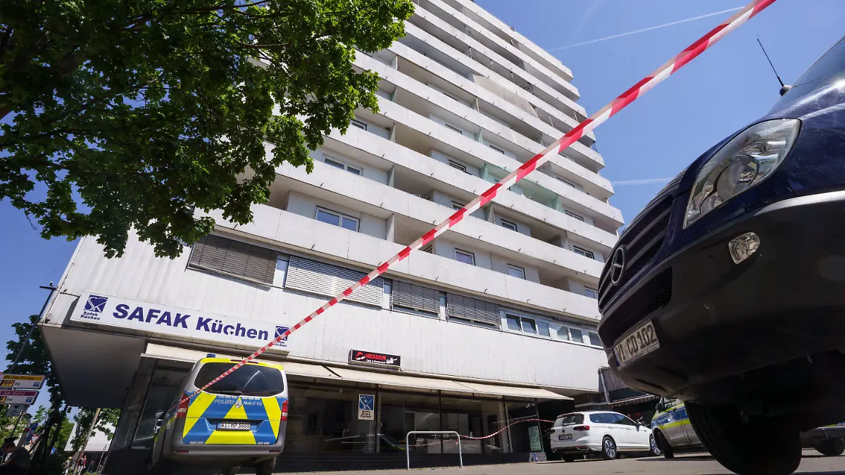 11.05.2022, Hessen, Hanau: Flatterband der Polizei hängt vor einem Hochhaus in dem am Morgen ein totes Mädchen gefunden wurde. Vor dem Haus lag auf der Straße ein schwer verletzter Junge, der später verstarb. Foto: Frank Rumpenhorst/dpa +++ dpa-Bildfunk +++