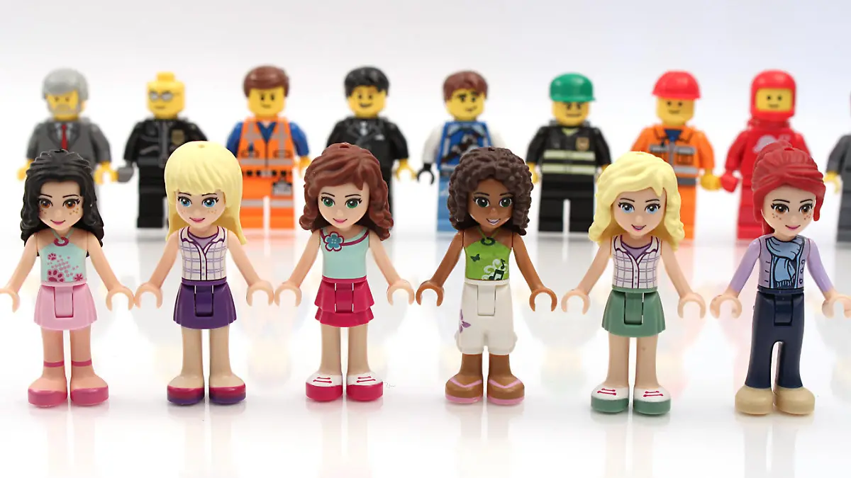 Colorado, USA - Feb. 18, 2015: Studio shot of a line of Lego Friends girls in front of line of minifigure boys. Lego minifigures and bricks are a popular line of plastic construction toys that are manufactured by The Lego Group, a privately held company based in Denmark.