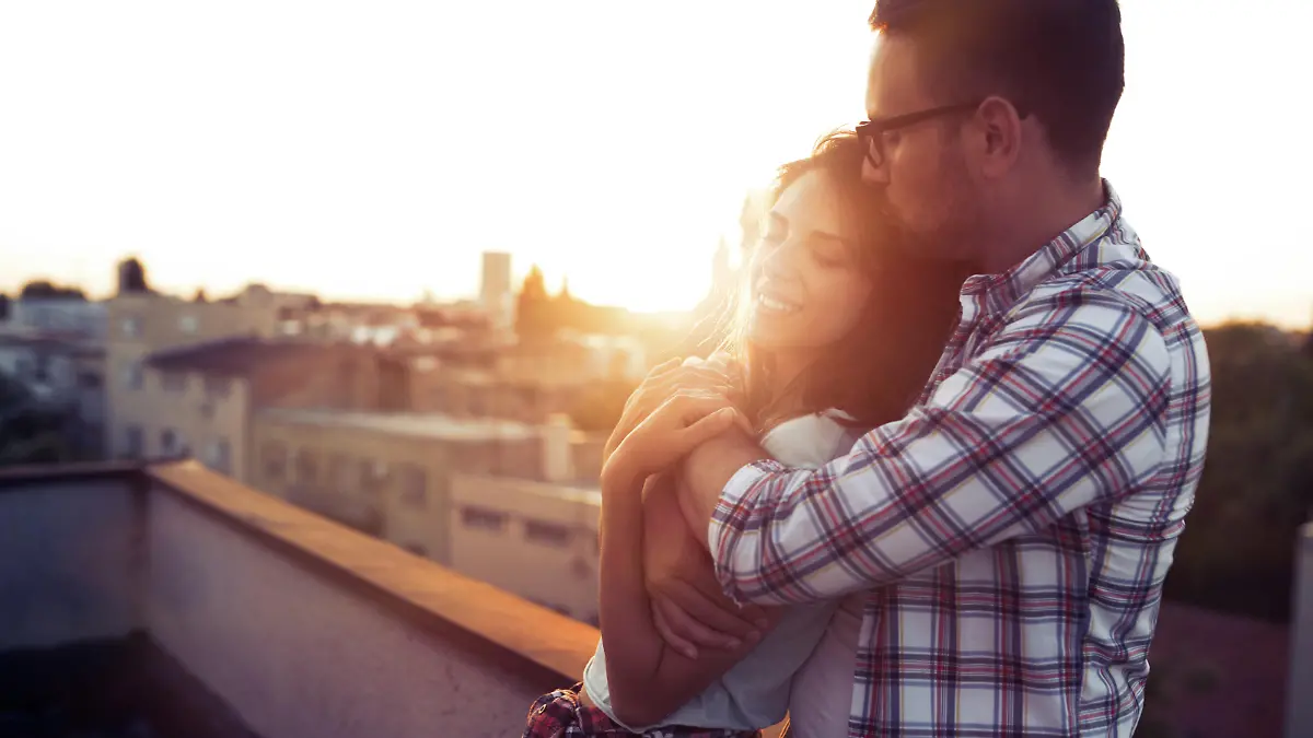 Beautiful young couple in love dating outdoors and smiling