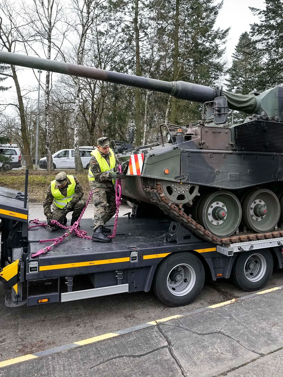 FILE - German soldiers load tank howitzers 2000 for transport to Lithuania at the Bundeswehr army base in Munster, northern Germany, Monday, Feb. 14, 2022. Germany's defense minister confirmed Friday that her country will supply Ukraine with seven powerful self-propelled howitzers to help defend itself against Russia. Christine Lambrecht said Ukrainian soldiers will be trained in Germany to use the self-propelled Panzerhaubitze 2000 artillery, which is capable of firing precision ammunition at a distance of up to 40 kilometers (25 miles). (AP Photo/Martin Meissner, File)