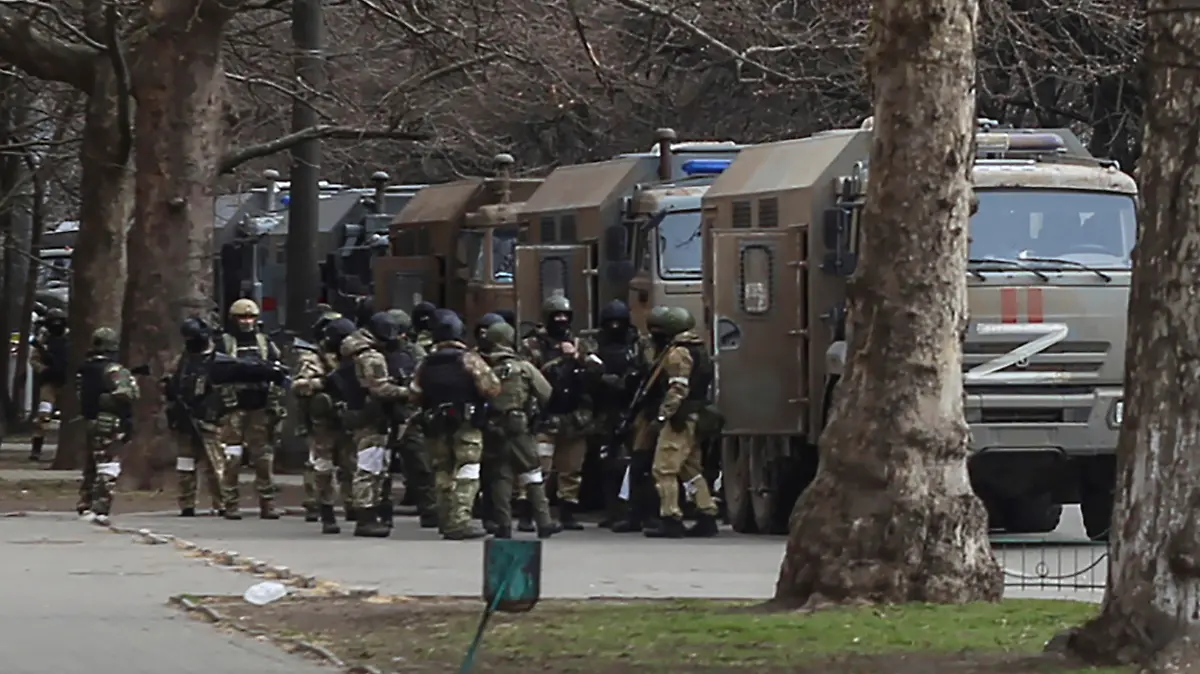 Russian army soldiers stand next to their trucks during a rally against Russian occupation in Svobody (Freedom) Square in Kherson, Ukraine, Monday, March 7, 2022. Ever since Russian forces took the southern Ukrainian city of Kherson in early March, residents sensed the occupiers had a special plan for their town. Now, amid a crescendo of warnings from Ukraine that Russia plans to stage a sham referendum to transform the territory into a pro-Moscow "people's republic," it appears locals guessed right. (AP Photo/Olexandr Chornyi)