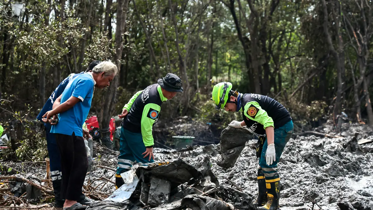 Rescue workers search the wreckage of a small aircraft a day after it crashed as five tourists from China and four Thais, including the two pilots, all presumed dead, in Bang Pakong, Chachoengsao province, Thailand, August 23, 2024.