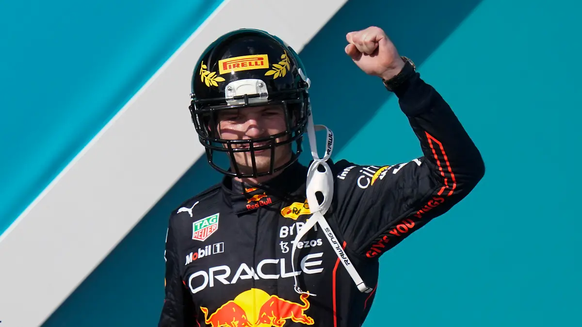 Red Bull driver Max Verstappen of the Netherlands takes the stage wearing a football helmet after winning the Formula One Miami Grand Prix auto race at the Miami International Autodrome, Sunday, May 8, 2022, in Miami Gardens, Fla. (AP Photo/Lynne Sladky)