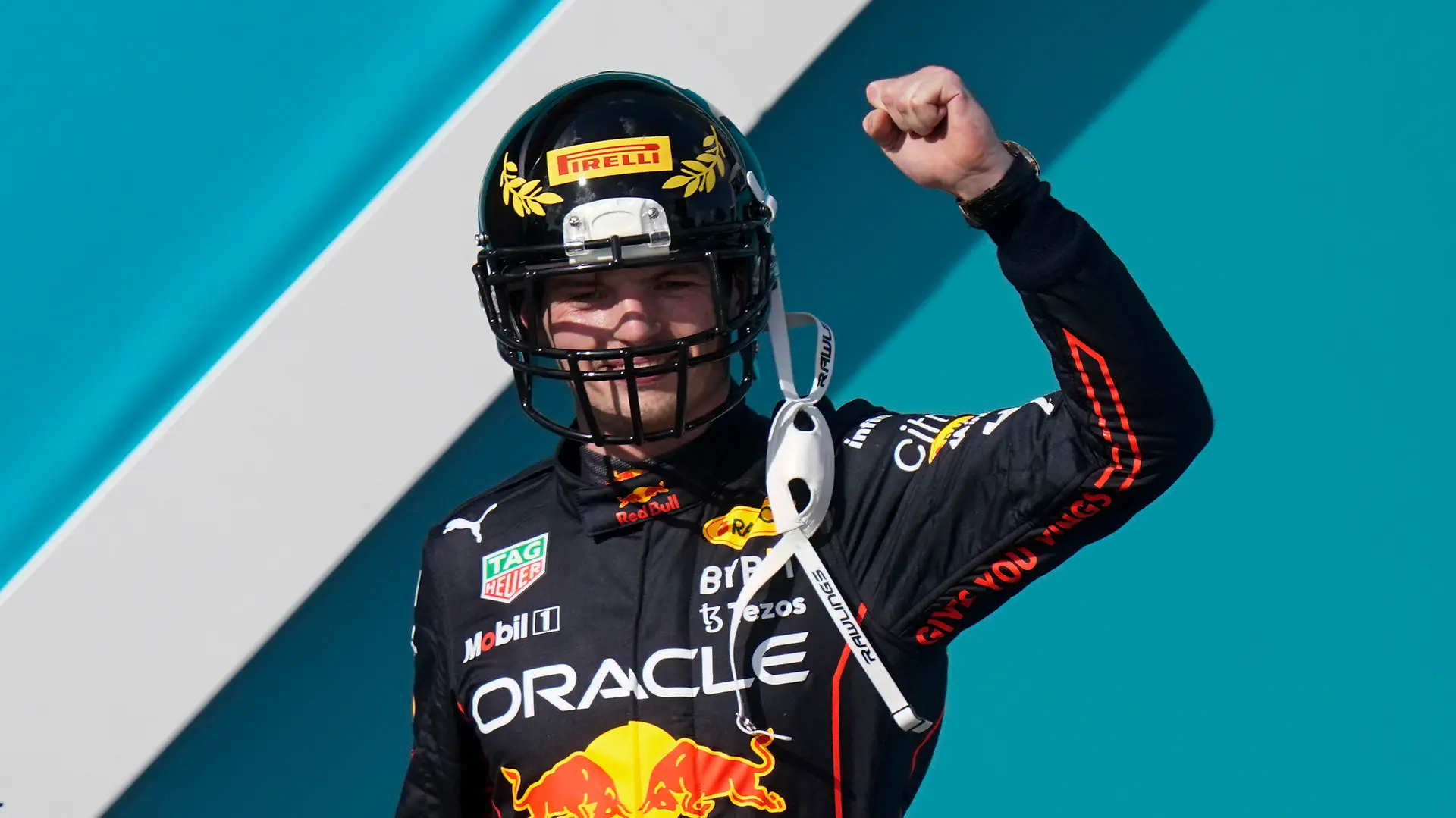 Red Bull driver Max Verstappen of the Netherlands takes the stage wearing a football helmet after winning the Formula One Miami Grand Prix auto race at the Miami International Autodrome, Sunday, May 8, 2022, in Miami Gardens, Fla. (AP Photo/Lynne Sladky)