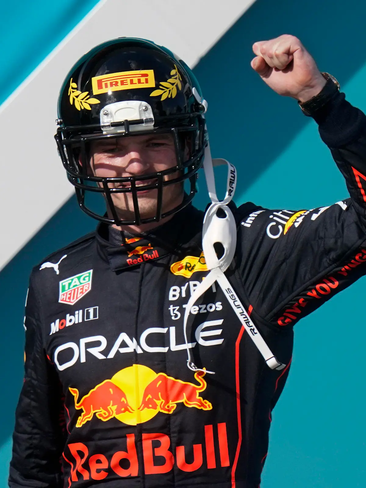 Red Bull driver Max Verstappen of the Netherlands takes the stage wearing a football helmet after winning the Formula One Miami Grand Prix auto race at the Miami International Autodrome, Sunday, May 8, 2022, in Miami Gardens, Fla. (AP Photo/Lynne Sladky)