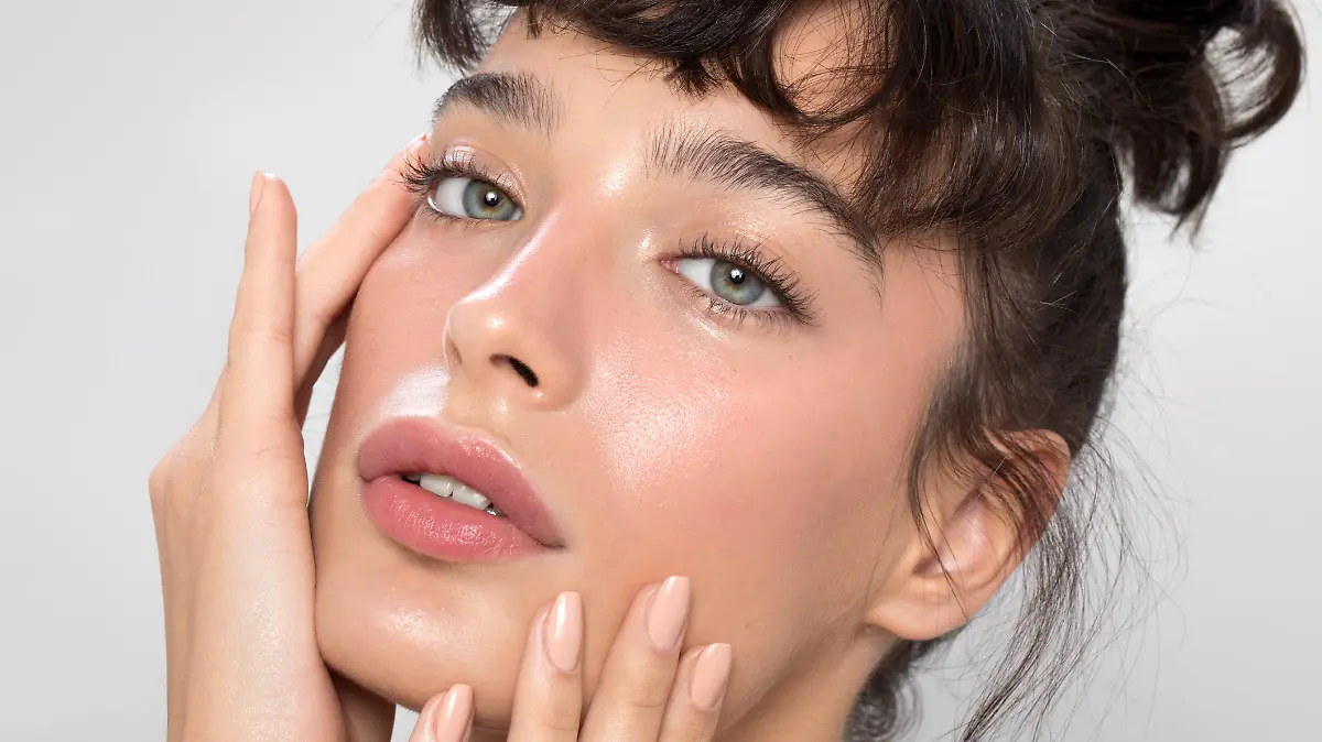 Close up studio shot of a beautiful woman with perfect skin, she touching her face