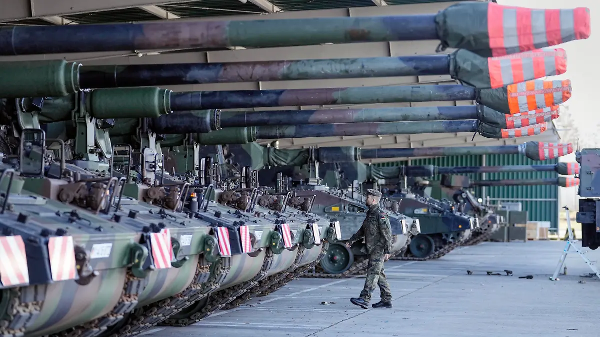 FILE - German soldiers walk beside tank howitzers 2000 prior transport to Lithuania at the Bundeswehr army base in Munster, northern Germany, Monday, Feb. 14, 2022. Germany's defense minister confirmed Friday that her country will supply Ukraine with seven powerful self-propelled howitzers to help defend itself against Russia. Christine Lambrecht said Ukrainian soldiers will be trained in Germany to use the self-propelled Panzerhaubitze 2000 artillery, which is capable of firing precision ammunition at a distance of up to 40 kilometers (25 miles). (AP Photo/Martin Meissner, File)