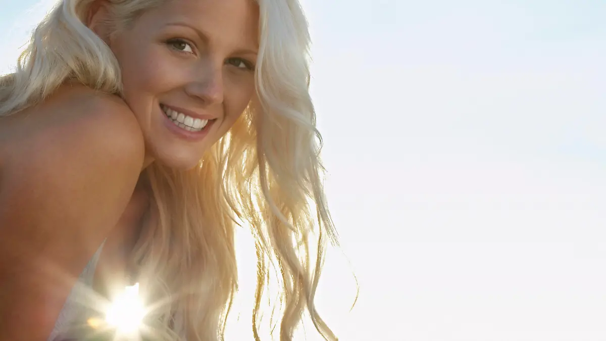 Young woman smiling close up portrait, model released, , 10026798.jpg, Outdoors,Day,Low Angle View,Close-Up,Young Adult,Portrait,One Person Only,Long Hair,Enjoyment,Smiling,Cheerful,Head And Shoulders,head,shoulders,headshot,Adult,Woman,Blonde Hair,20-25 Years,Young Adult Woman,Young,Copy Space,The Sun,Attractive,Sunset,Wavy Hair,Sunlight,Lens Flare,toothy smile,Looking At Camera, Herne Bay Beach