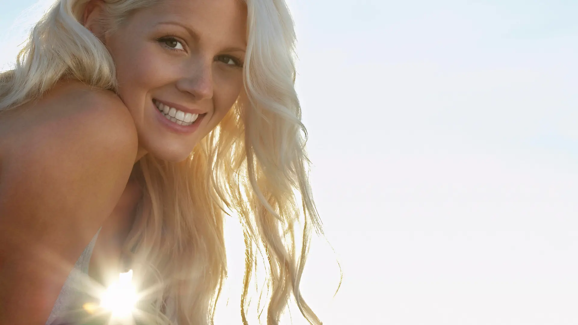 Young woman smiling close up portrait, model released, , 10026798.jpg, Outdoors,Day,Low Angle View,Close-Up,Young Adult,Portrait,One Person Only,Long Hair,Enjoyment,Smiling,Cheerful,Head And Shoulders,head,shoulders,headshot,Adult,Woman,Blonde Hair,20-25 Years,Young Adult Woman,Young,Copy Space,The Sun,Attractive,Sunset,Wavy Hair,Sunlight,Lens Flare,toothy smile,Looking At Camera, Herne Bay Beach