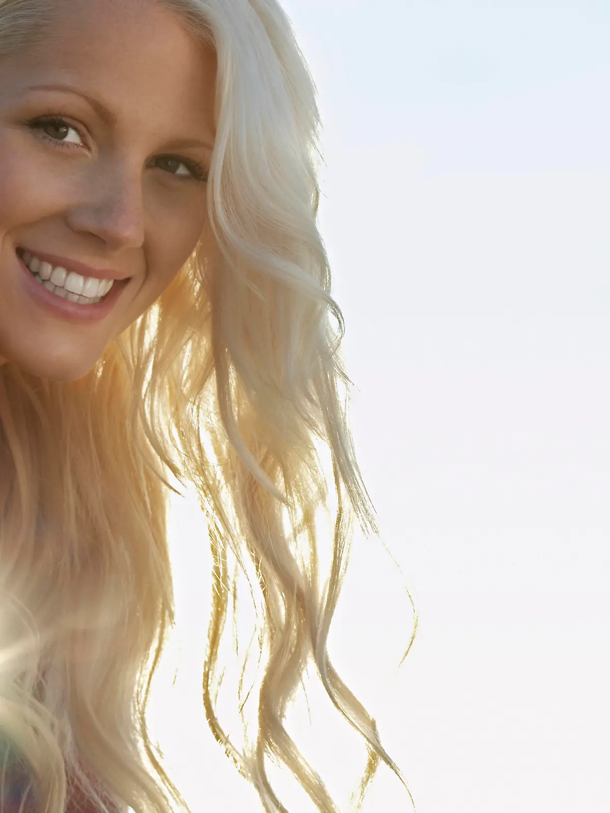 Young woman smiling close up portrait, model released, , 10026798.jpg, Outdoors,Day,Low Angle View,Close-Up,Young Adult,Portrait,One Person Only,Long Hair,Enjoyment,Smiling,Cheerful,Head And Shoulders,head,shoulders,headshot,Adult,Woman,Blonde Hair,20-25 Years,Young Adult Woman,Young,Copy Space,The Sun,Attractive,Sunset,Wavy Hair,Sunlight,Lens Flare,toothy smile,Looking At Camera, Herne Bay Beach