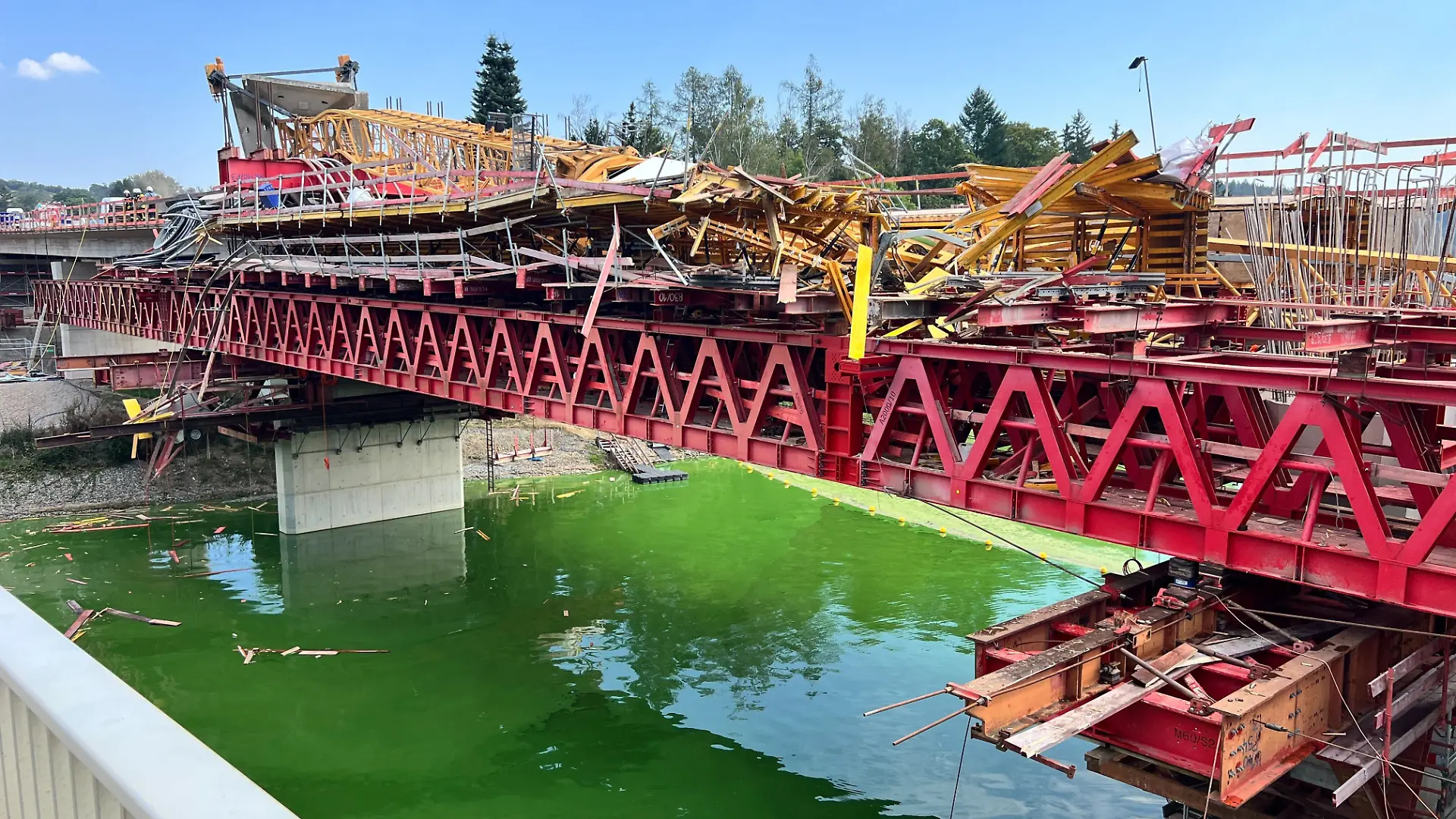 Ein umgestürzter Kran liegt auf einer Brücke, die sich im Bau befindet.