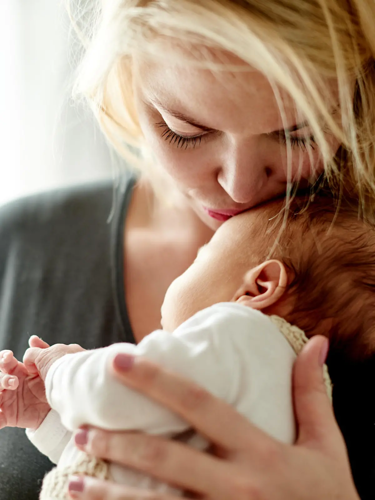 Shot of a mother spending time with her newborn baby