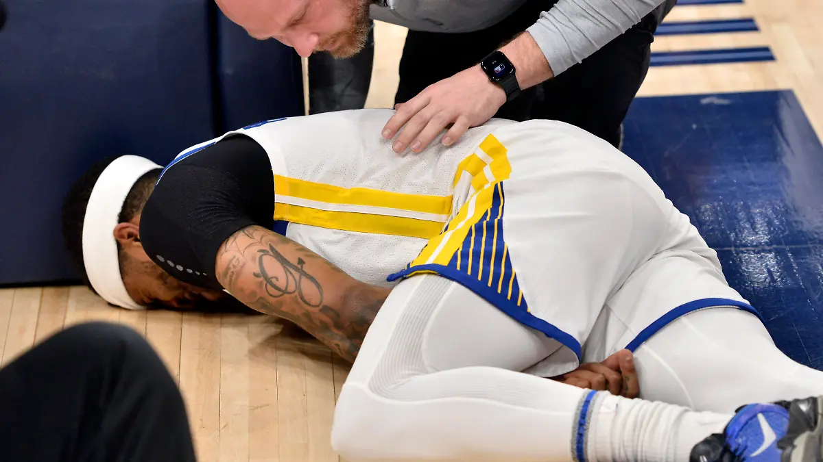 Golden State Warriors guard Gary Payton II lies on the court after being fouled during the first half of Game 2 of the team's second-round NBA basketball playoff series against the Memphis Grizzlies on Tuesday, May 3, 2022, in Memphis, Tenn. (AP Photo/Brandon Dill)