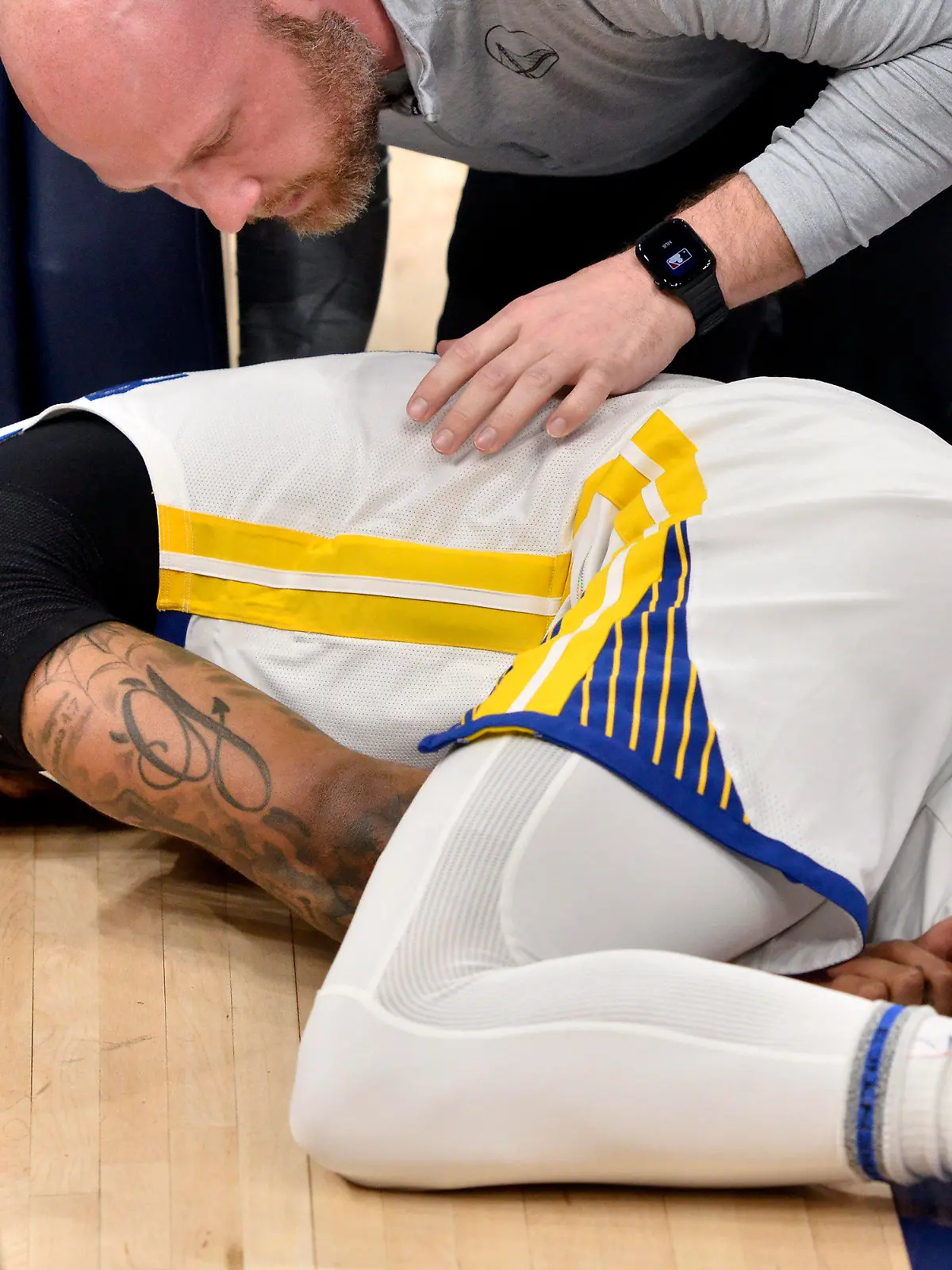 Golden State Warriors guard Gary Payton II lies on the court after being fouled during the first half of Game 2 of the team's second-round NBA basketball playoff series against the Memphis Grizzlies on Tuesday, May 3, 2022, in Memphis, Tenn. (AP Photo/Brandon Dill)
