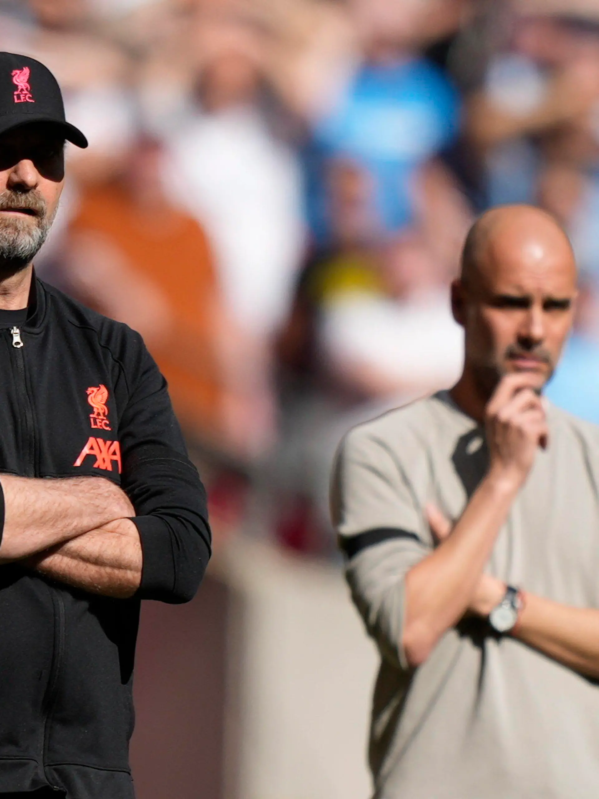 Liverpool's manager Jurgen Klopp, left, and Manchester City's head coach Pep Guardiola stand on the touchline during the English FA Cup semifinal soccer match between Manchester City and Liverpool at Wembley stadium in London, Saturday, April 16, 2022. (AP Photo/Frank Augstein)