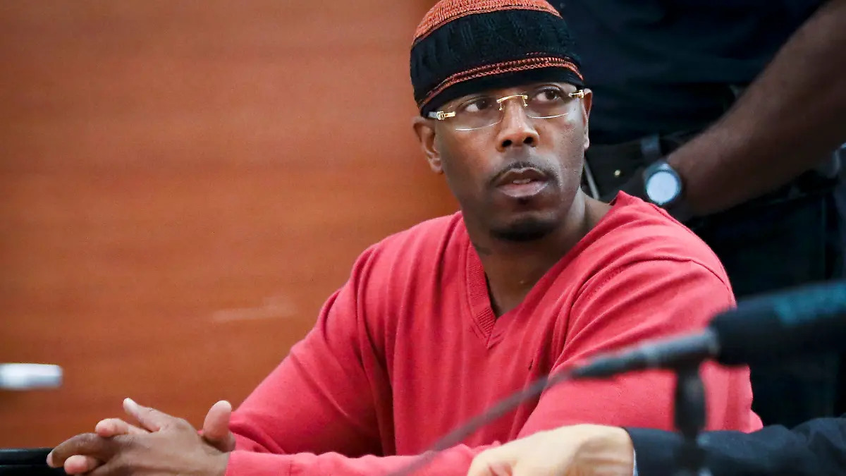 FILE - In this May 5, 2017, photo file photo, Calvin Buari listens during a hearing at Bronx Criminal Court to vacate his double murder conviction, in New York. Prosecutors dropped charges Wednesday, March 21, 2018, against Buari who spent 22 years in prison for a double killing before new witnesses came forward and his conviction was overturned. 