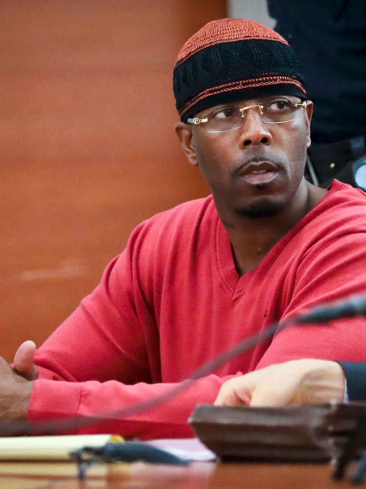 FILE - In this May 5, 2017, photo file photo, Calvin Buari listens during a hearing at Bronx Criminal Court to vacate his double murder conviction, in New York. Prosecutors dropped charges Wednesday, March 21, 2018, against Buari who spent 22 years in prison for a double killing before new witnesses came forward and his conviction was overturned. 