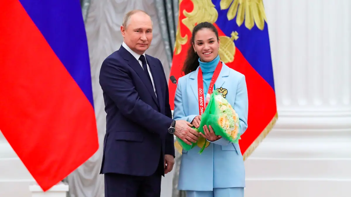 Russian President Vladimir Putin poses for a photo with Olympic champion in cross-country skiing Veronika Stepanova during an awarding ceremony for the Russian Olympic Committee's medalists of the XXIV Olympic Winter Games in Beijing and members of the Russian Paralympic team in the Kremlin in Moscow, Russia, Tuesday, April 26, 2022. (Vladimir Astapkovich, Sputnik, Kremlin Pool Photo via AP)