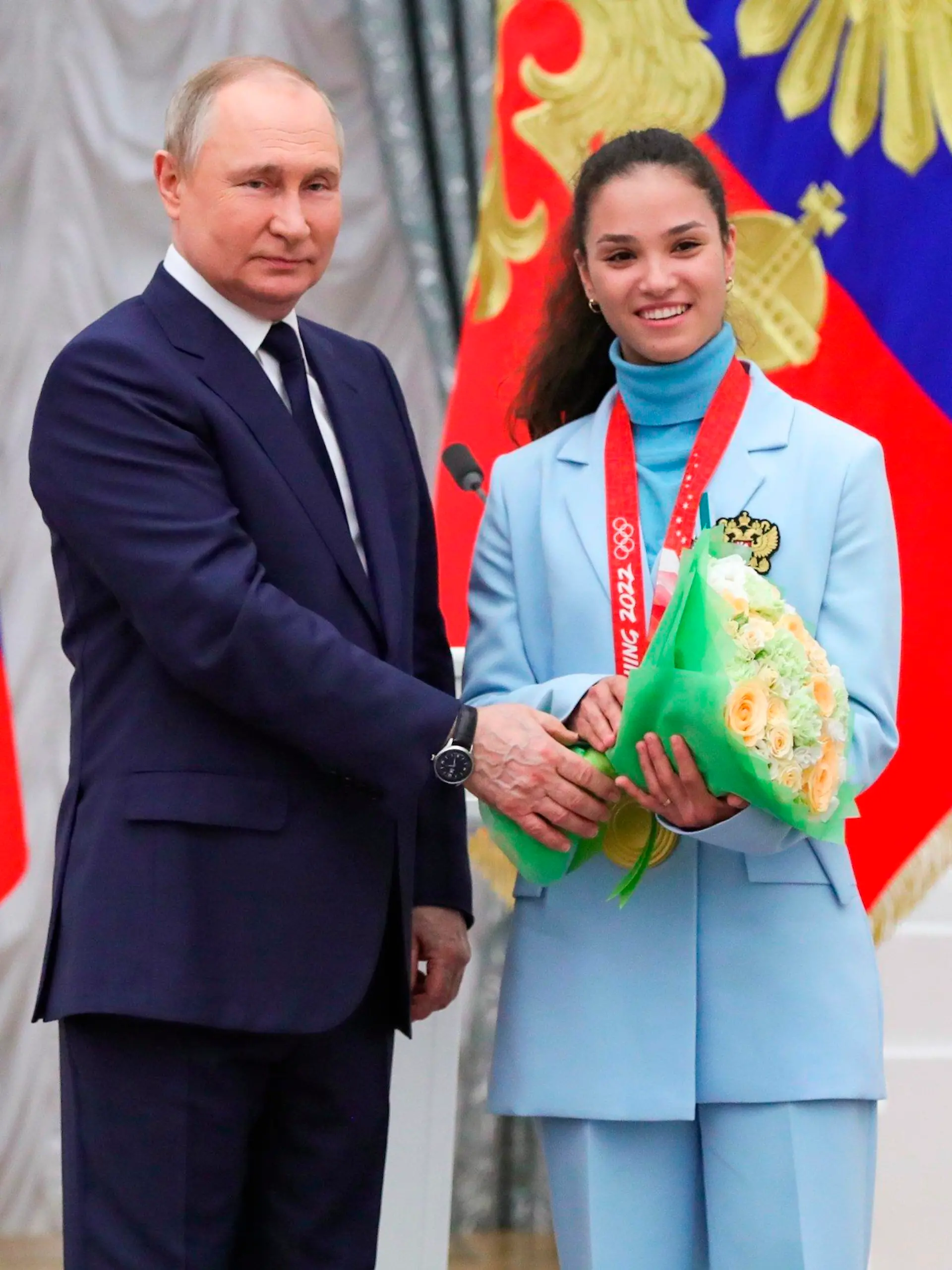 Russian President Vladimir Putin poses for a photo with Olympic champion in cross-country skiing Veronika Stepanova during an awarding ceremony for the Russian Olympic Committee's medalists of the XXIV Olympic Winter Games in Beijing and members of the Russian Paralympic team in the Kremlin in Moscow, Russia, Tuesday, April 26, 2022. (Vladimir Astapkovich, Sputnik, Kremlin Pool Photo via AP)
