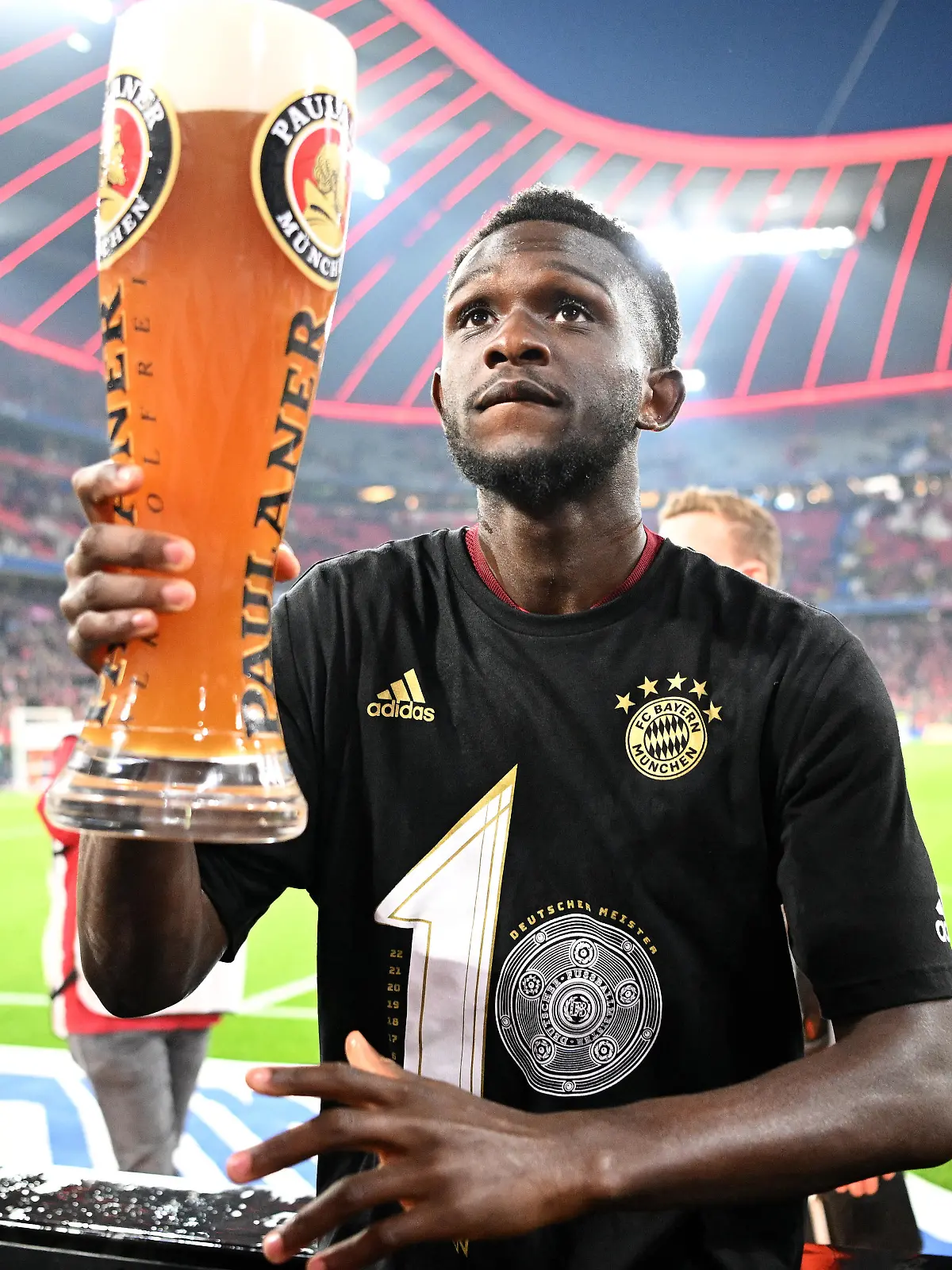 MUNICH, GERMANY - APRIL 23: Tanguy Nianzou of FC Bayern Muenchen celebrates with the fans after their sides victory during the Bundesliga match between FC Bayern Muenchen and Borussia Dortmund at Allianz Arena on April 23, 2022 in Munich, Germany. (Photo by Stuart Franklin/Getty Images)
